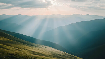 Wall Mural - Sun rays shining through clouds over a mountain range.