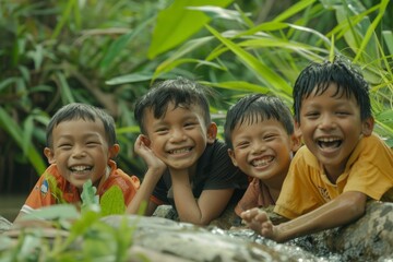 Group of happy asian kids smiling and playing at the waterfall.