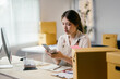 © PaeGAG - Young asia business woman is counting banknote money after receiving order from online shopping platform at home office