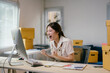 © PaeGAG - Young asian woman running a small business is working on her computer and celebrating receiving good news such as achieving a sale or receiving a large order