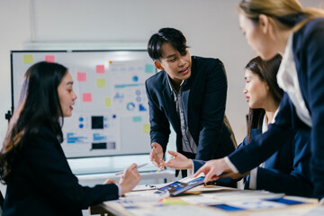 Poster - Team of asian businesspeople are having a productive meeting, discussing financial data and developing new company strategies