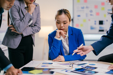 Poster - Group of asian businesspeople are working together in a modern office, analyzing financial data and having a discussion