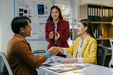 Poster - Business partners celebrating success after signing a contract in a modern office, happy and smiling with colleagues