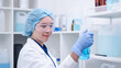 © Supapich - Woman scientist chemist holding laboratory blue liquid beaker test tube equipment for discovery analysis science chemical medicine development experiment technology biotechnology development