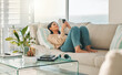 © DavisShared/peopleimages.com - Home, relax and woman with phone on sofa for social media, online chatting and reading message. Happy, couch and girl on smartphone for communication, website and internet in living room on weekend
