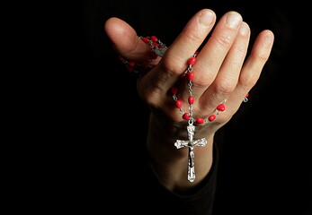 praying to god with hands together with crucifix cross on black background with people stock photo stock image