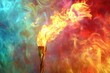 © shobakhul - Golden Torch with Flames Against a Colorful Smoky Background