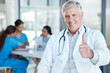 © CineLens2024/peopleimages.com - Healthcare, doctor and portrait of man with thumbs up for success, approval and great service. Medical, excellence and mature worker with gesture at hospital for thank you, agreement and motivation