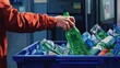 © Johannes - Generative AI illustration of an anonymous person in a red sleeve recycling a green plastic bottle, placing it into a blue bin filled with assorted recyclables