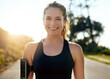 © SunriseDon/peopleimages.com - Happy woman, portrait and runner with earphones on road for workout, cardio or outdoor exercise. Young, female person or athlete with smile for music, podcast or fitness on asphalt, path or street