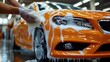 © At My Hat - Orange car being washed with foam. Perfect for advertising car wash services, detailing, or cleaning products.