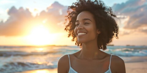 Canvas Print - Carefree Afro woman walking along the beach with a smile.