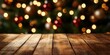 © Karn AS Images - Wooden table with outoffocus Christmas tree and glowing ornaments in the background, warm holiday lighting, cozy festive atmosphere, shallow depth of field, rustic inviting scene
