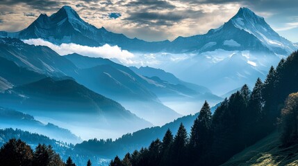  Majestic mountain range with snow-capped peaks, lush forest and fog in the valleys.