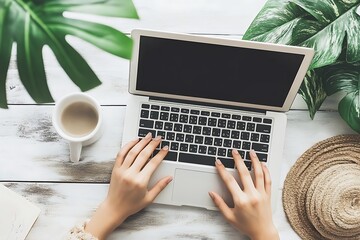 Woman typing on a laptop with blank screen