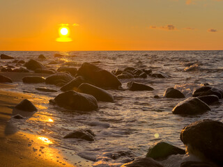 sunset on the beach with rocks on the baltic sea, isalnd Rügen in Germany