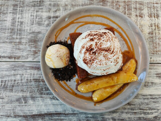 Honey toast and vanilla ice cream with whipping cream and banana