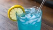 © cherif - a cold blue drink with a straw and a slice of lemon on the rim