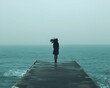 © Thares2020 - Person Standing on Pier Overlooking Calm Ocean Symbolizing Inner Peace and Freedom