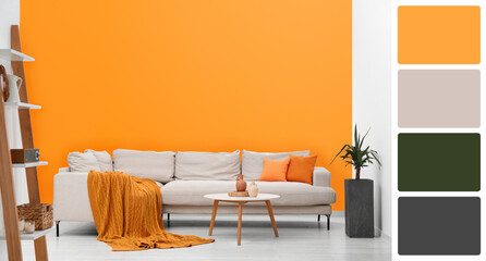 Stylish living room with comfortable sofa near orange wall. Interior design and matching color palette