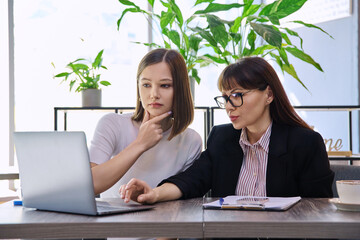 Female psychologist, social worker talking and working with young woman