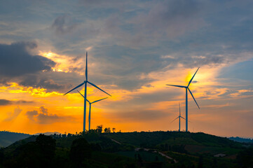 wind turbine in the countryside in the time of sunset background. Wind Turbines at Sunset. Aerial view of a wind farm at sunset,Khao Kho,Petchabun province,Thailand,ASIA.