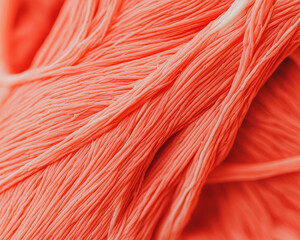 Poster - A close-up of soft, coral-colored yarn, showcasing its delicate fibers and texture, perfect for crafting and knitting projects.