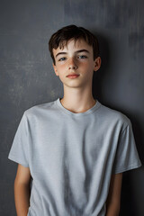 Wall Mural - Teenage boy wearing t-shirt on grey background