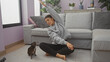 © Krakenimages.com - Young woman stretching in her living room along with her chihuahua, depicting a cozy home workout scenario.