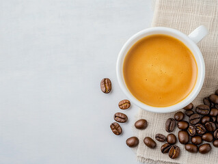 hot espresso and coffee bean on white table with soft-focus and over light in the background. top view