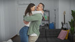 © Krakenimages.com - A happy couple sharing a loving embrace in the comfort of their modern living room.