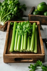 Wall Mural - Freshly harvested celery arranged in a rustic wooden crate on a kitchen countertop