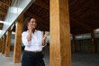 © Taras Grebinets - Confident professional woman talking on phone in modern wooden building