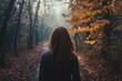 © StockUp - A woman with long hair walks through a misty autumn forest path surrounded by falling leaves.