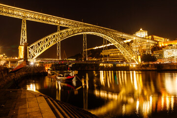 View of the beautiful steel bridge over the Duero River in Porto in the evening