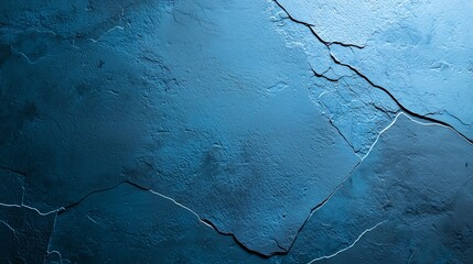 A textured blue surface featuring cracks, evoking a cool, tranquil aesthetic suitable for backgrounds or artistic designs.