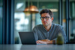 © Impressionstock - Focused Businessman Working on Laptop in Modern Office
