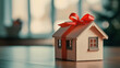 © Nemanja - House home gift wrapped present with ribbon and bow, red accents symbolize giving, ownership dream realized, wrapped property with copy space