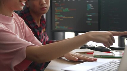 Back end software developer engineer for computer programming working together on debugging writing computing code, solving complex algorithms display on monitor in office. Burgeoning