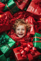 the happy little kid is in between the red and green gift boxes for x'mas party in the decorated living room graphic picture of the christmas decoration party