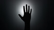 © ChrisKuz - Silhouette of an outstretched hand against a bright light, creating a dramatic and mysterious atmosphere