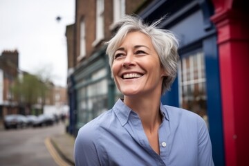 Sticker - Portrait of a happy mature woman smiling at the camera in the city