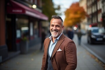 Sticker - Handsome mature man walking on a city street in autumn.