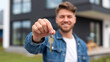 © Ozgurluk Design - Man Holding Key to New Home Ownership Happiness