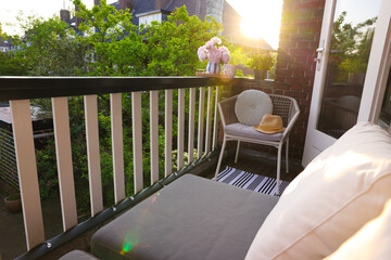 Wall Mural - Different plants on railings and chair at cozy balcony outdoors