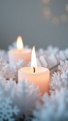 two lit candles resting a bed white decorations