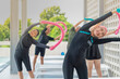 © ultramansk - group of joyful seniors participates in a fun water exercise class outdoors, using colorful pool noodles for stretching and balance. They are engaged in a fitness routine, staying active and healthy.