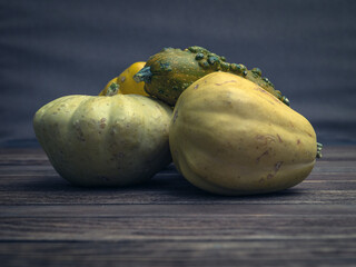 Cucurbita fruits on wooden desk. Close-up