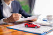 © doidam10 - Client decided to buy new car, reviewing auto loan agreements, insurance contract, and other business documents needed for vehicle purchase. loan, business, car, agreements, contract, vehicle, client.