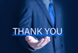 © WICHAI - Businessman using laptop and showing thank you message on display. Concept of congratulation, appreciation. Presentation from digital technology. Thank you in business and gratitude.